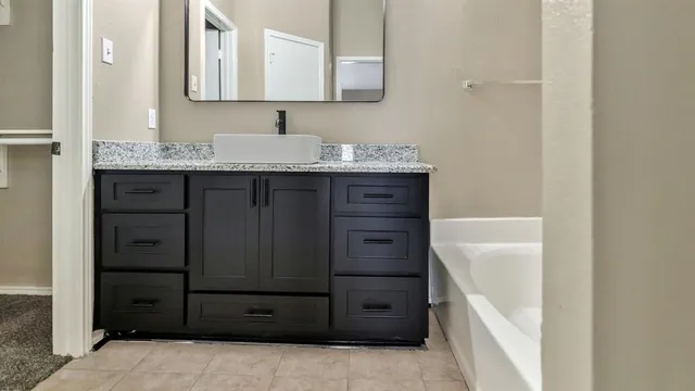 a bathroom with a sink vanity and mirror
