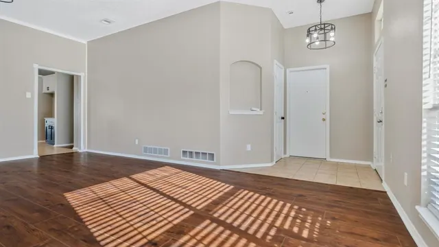 a view of a room with wooden floor and closet