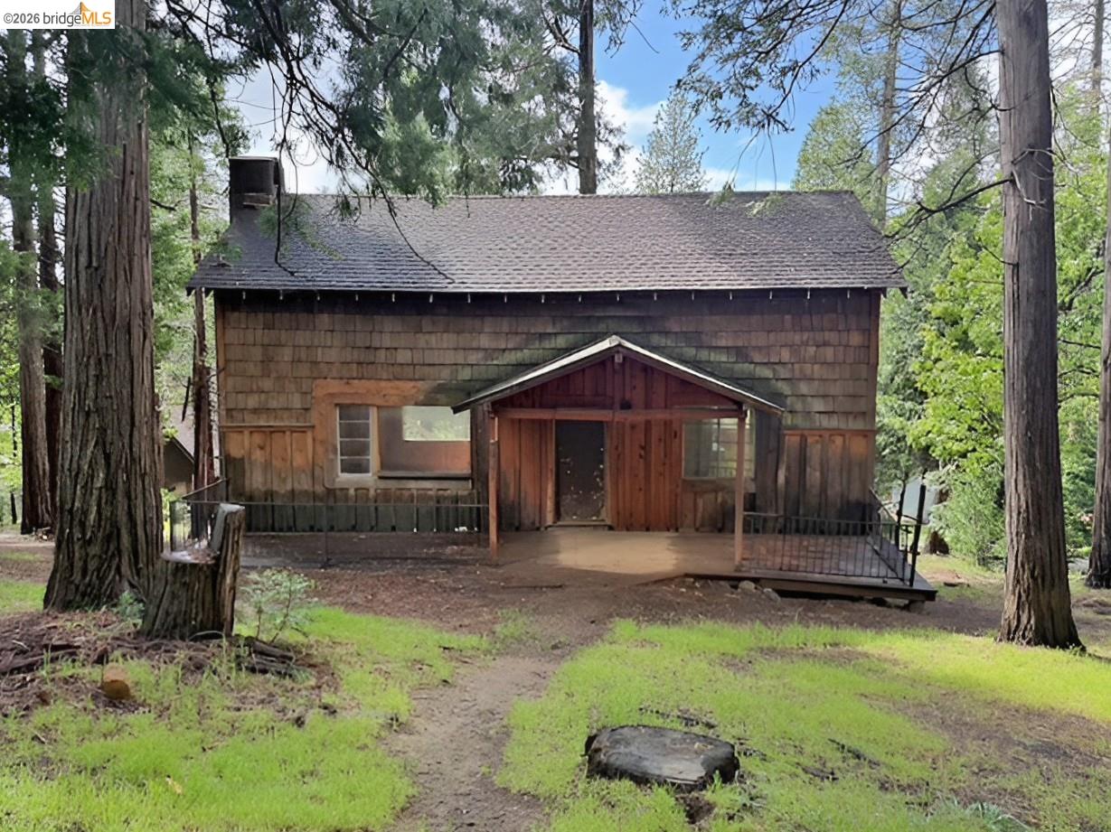 20693 Muheli Road Mi Wuk Village, CA 95346 - Photo 3 of 15 a front view of a house with a yard