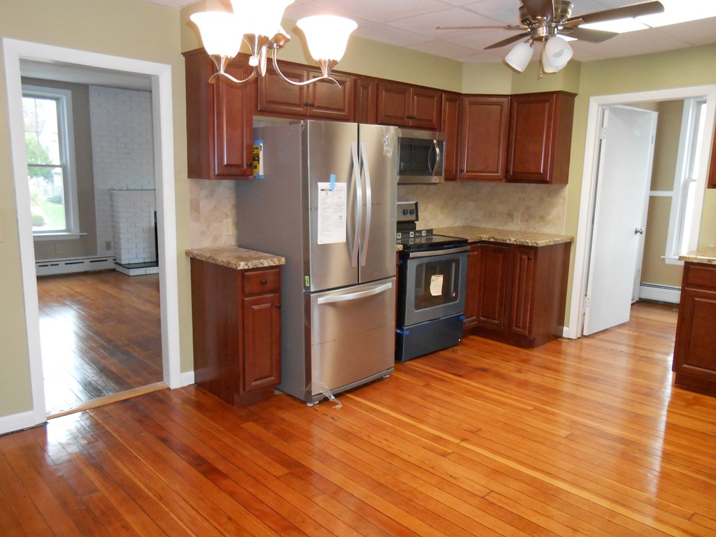 20 Lawrence Road Chicopee, MA 01013 - Photo 5 of 20 a kitchen with granite countertop wooden floors appliances and cabinets
