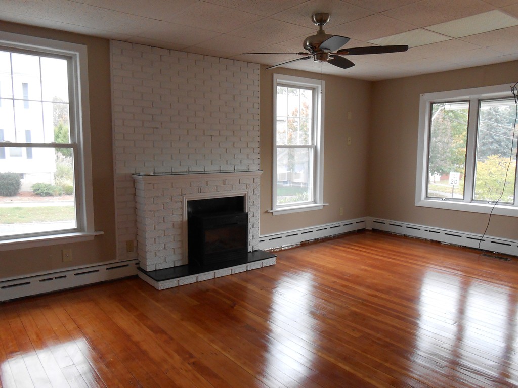 20 Lawrence Road Chicopee, MA 01013 - Photo 9 of 20 an empty room with wooden floor fireplace and windows