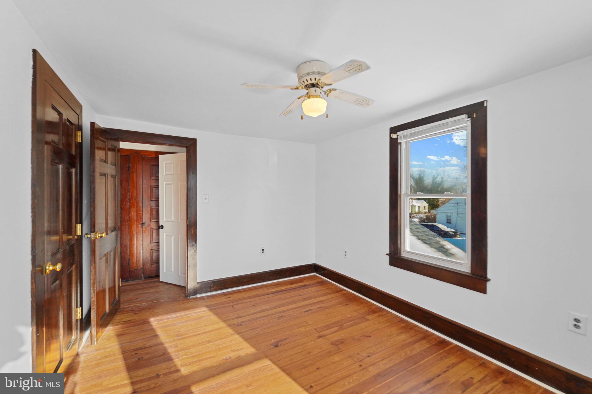 200 Union Street Salem, NJ 08079 - Photo 25 of 43 a view of an empty room with window and wooden floor