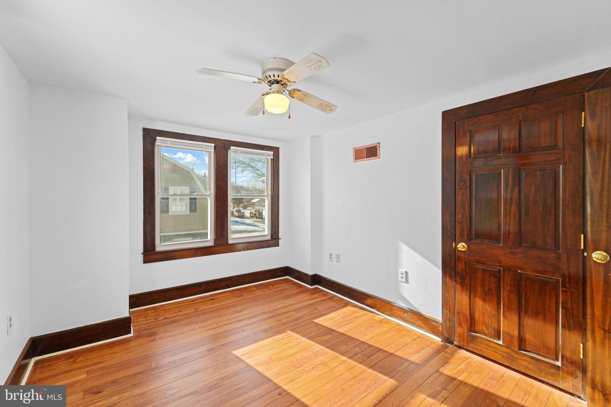200 Union Street Salem, NJ 08079 - Photo 28 of 43 a view of an empty room with window and wooden floor