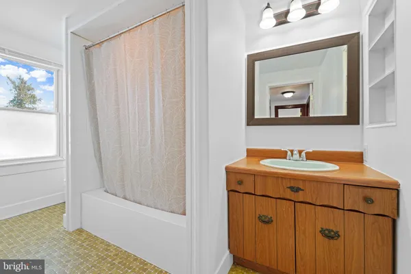 a bathroom with a sink a vanity and a mirror