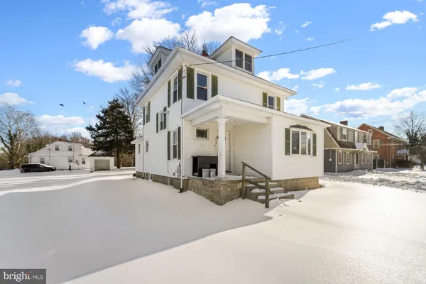 a view of a house with a snow on the road