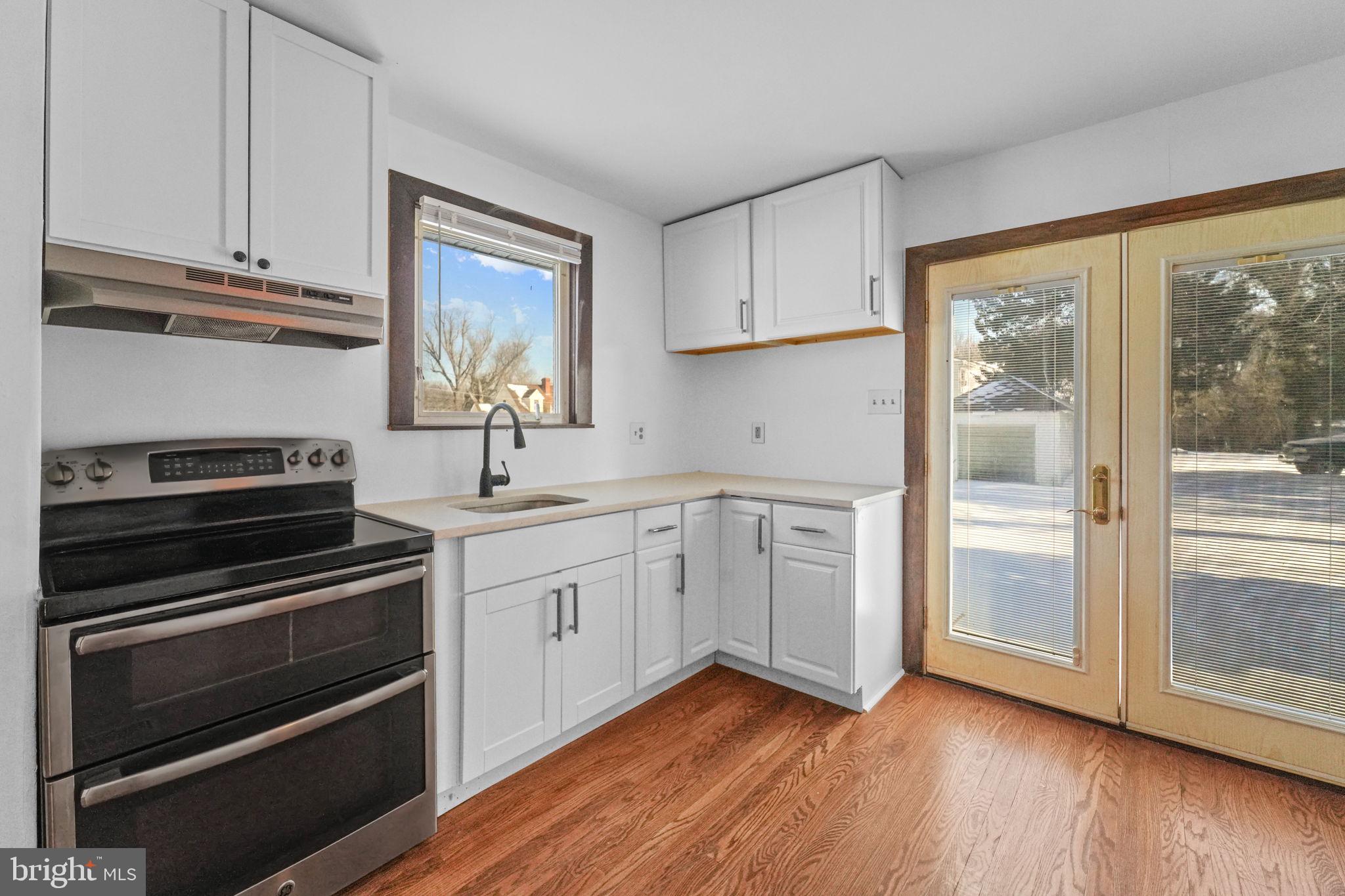 200 Union Street Salem, NJ 08079 - Photo 6 of 43 a kitchen with appliances cabinets and a wooden floor