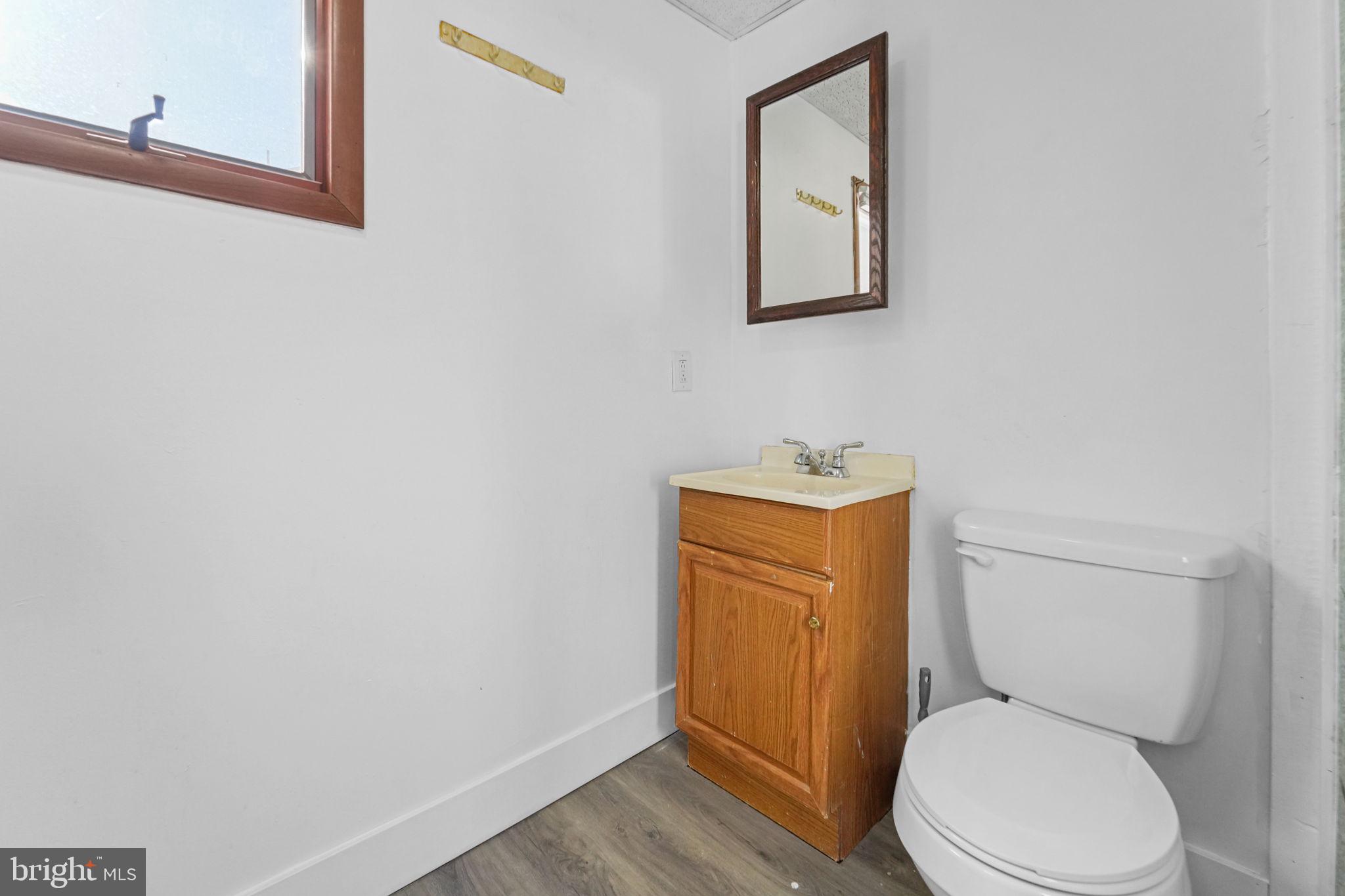 200 Union Street Salem, NJ 08079 - Photo 10 of 43 a white toilet sitting next to a bathroom sink