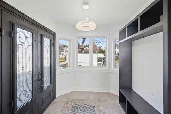 a view of an entryway with wooden floor and door