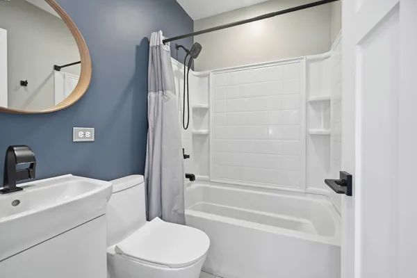 a bathroom with a toilet a sink and bathtub