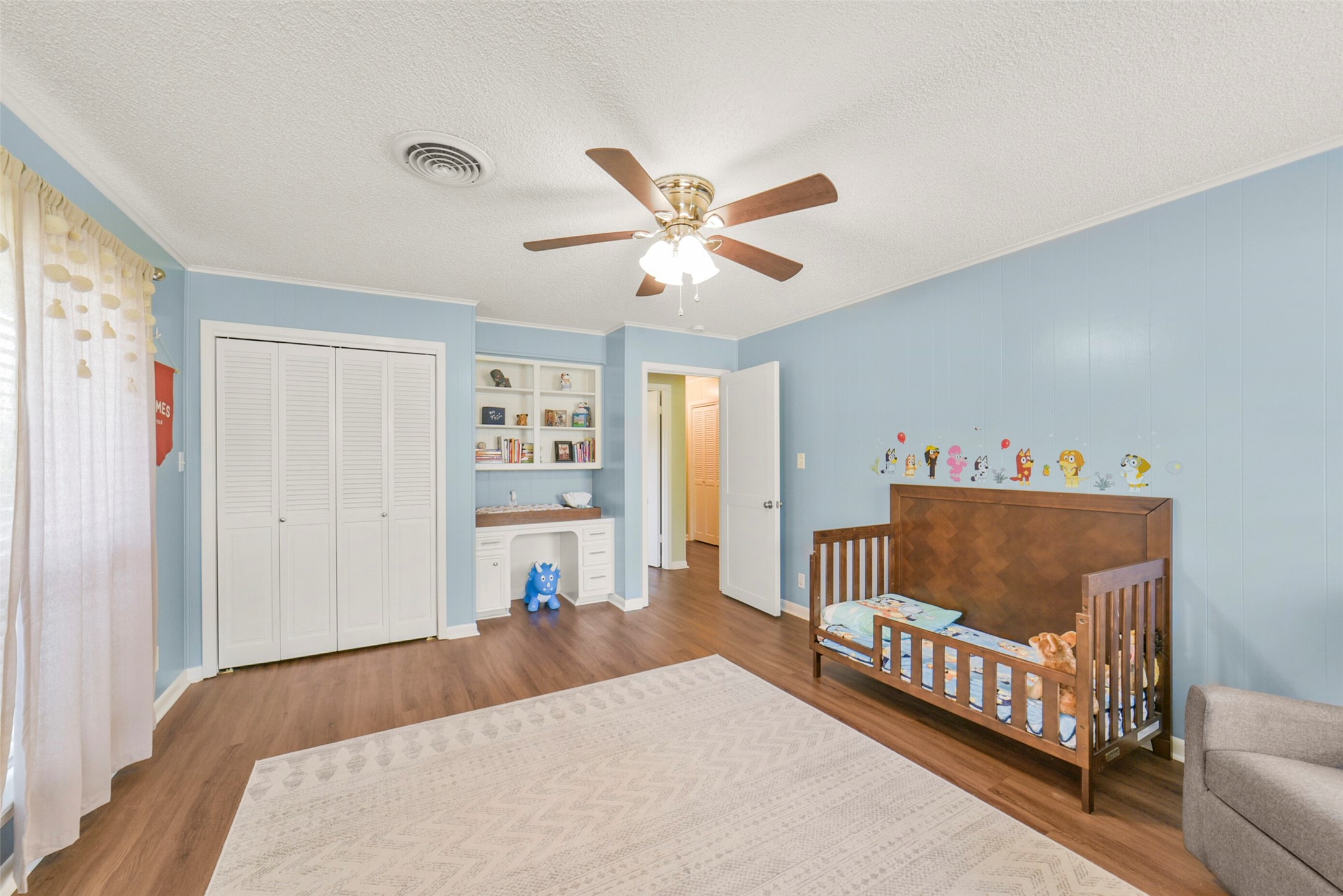 10313 South Williams Road Conroe, TX 77303 - Photo 29 of 48 Bedroom #2 with a view of closet and built in desk and shelving