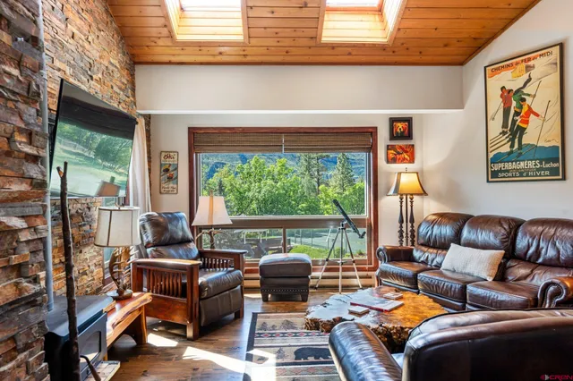 a living room with furniture and a floor to ceiling window