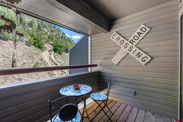 a couple of chairs sitting in a balcony