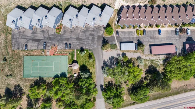 an aerial view of multiple houses with yard