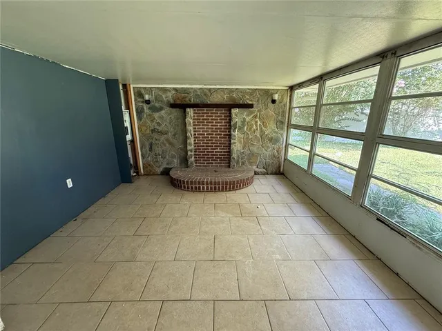 a view of an empty room with windows