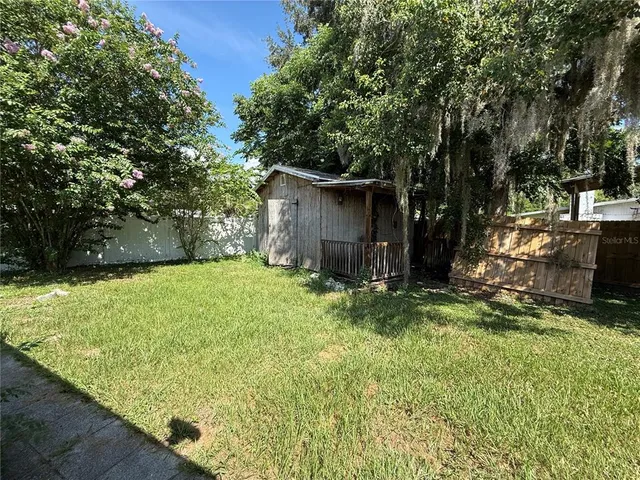 a backyard of a house with yard and trampoline