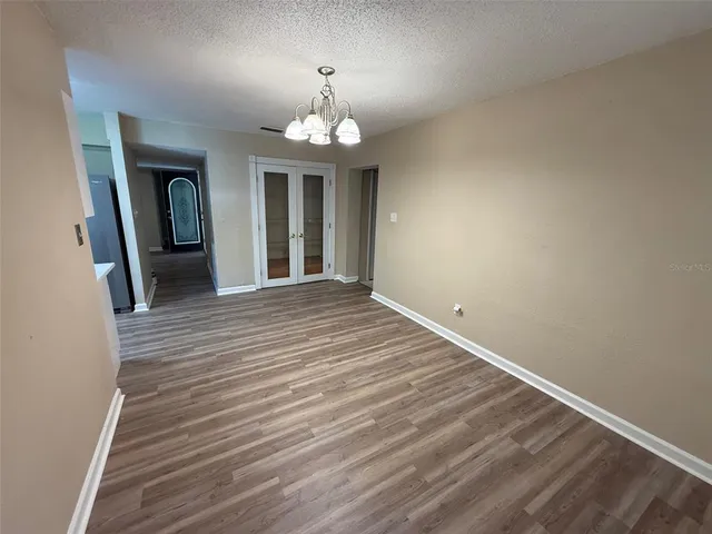 a view of a livingroom with wooden floor and a ceiling fan