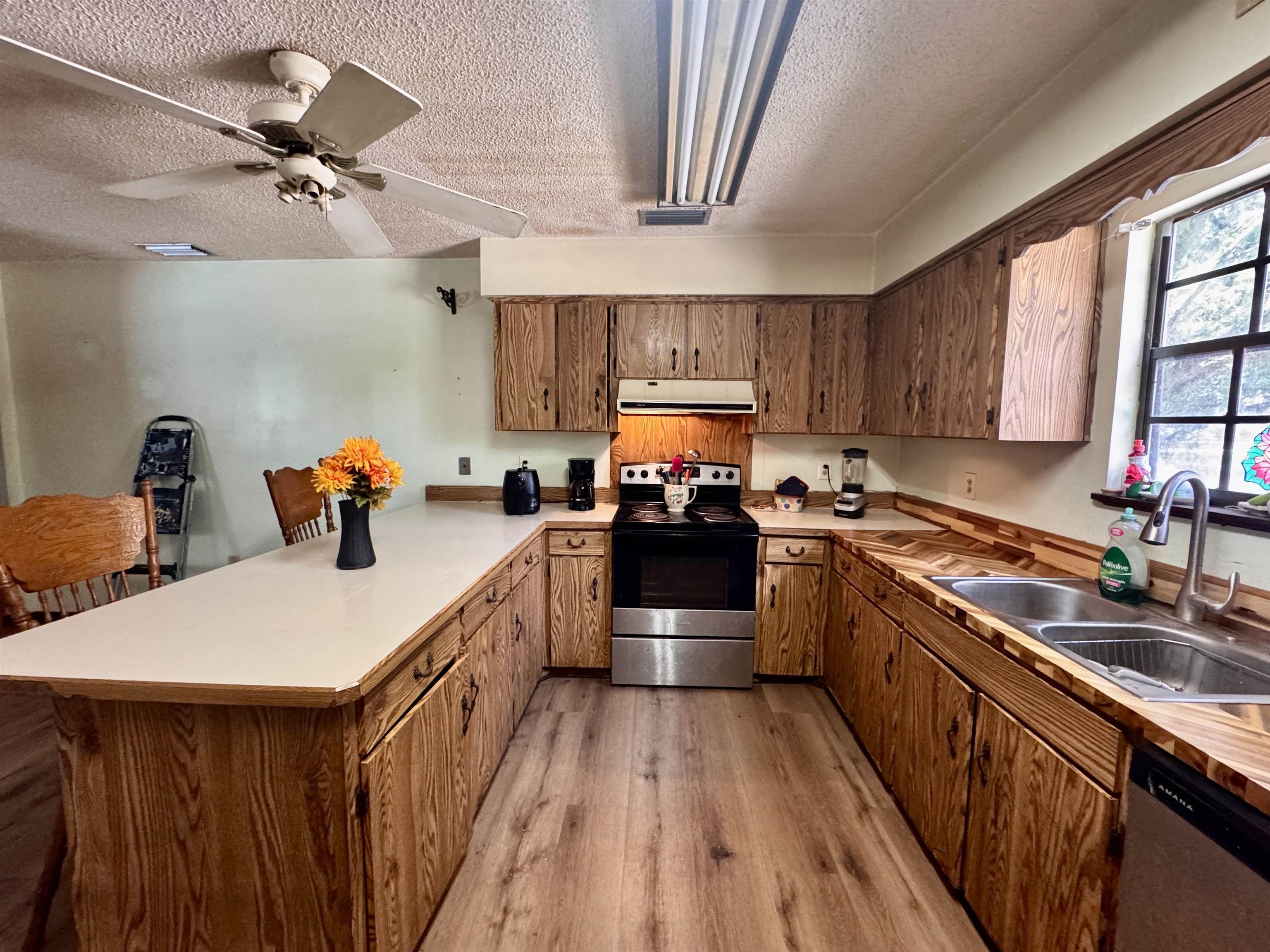 554 Hayley Road St. Augustine, FL 32086 - Photo 16 of 46 a kitchen with a sink appliances wooden floor and a window