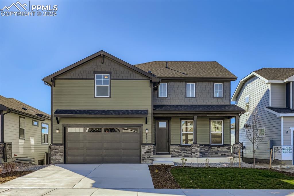 Craftsman-style home featuring roof with shingles, stone siding, concrete driveway, a porch, and a garage