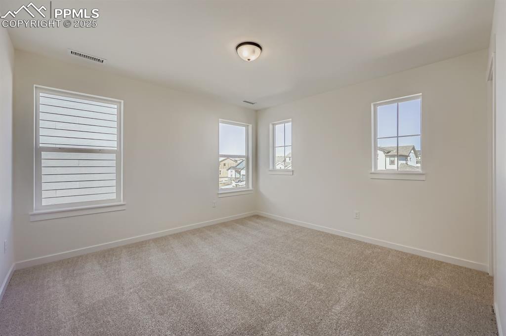 7989 Polson Drive Colorado Springs, CO 80908 - Photo 21 of 28 Empty room featuring carpet flooring and baseboards