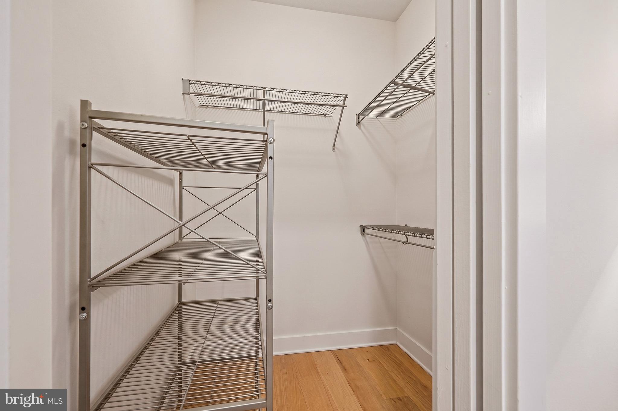 1402 12th Street Northwest, Unit 3 Washington, DC 20005 - Photo 19 of 23 a view of an empty walk in closet with wooden floor