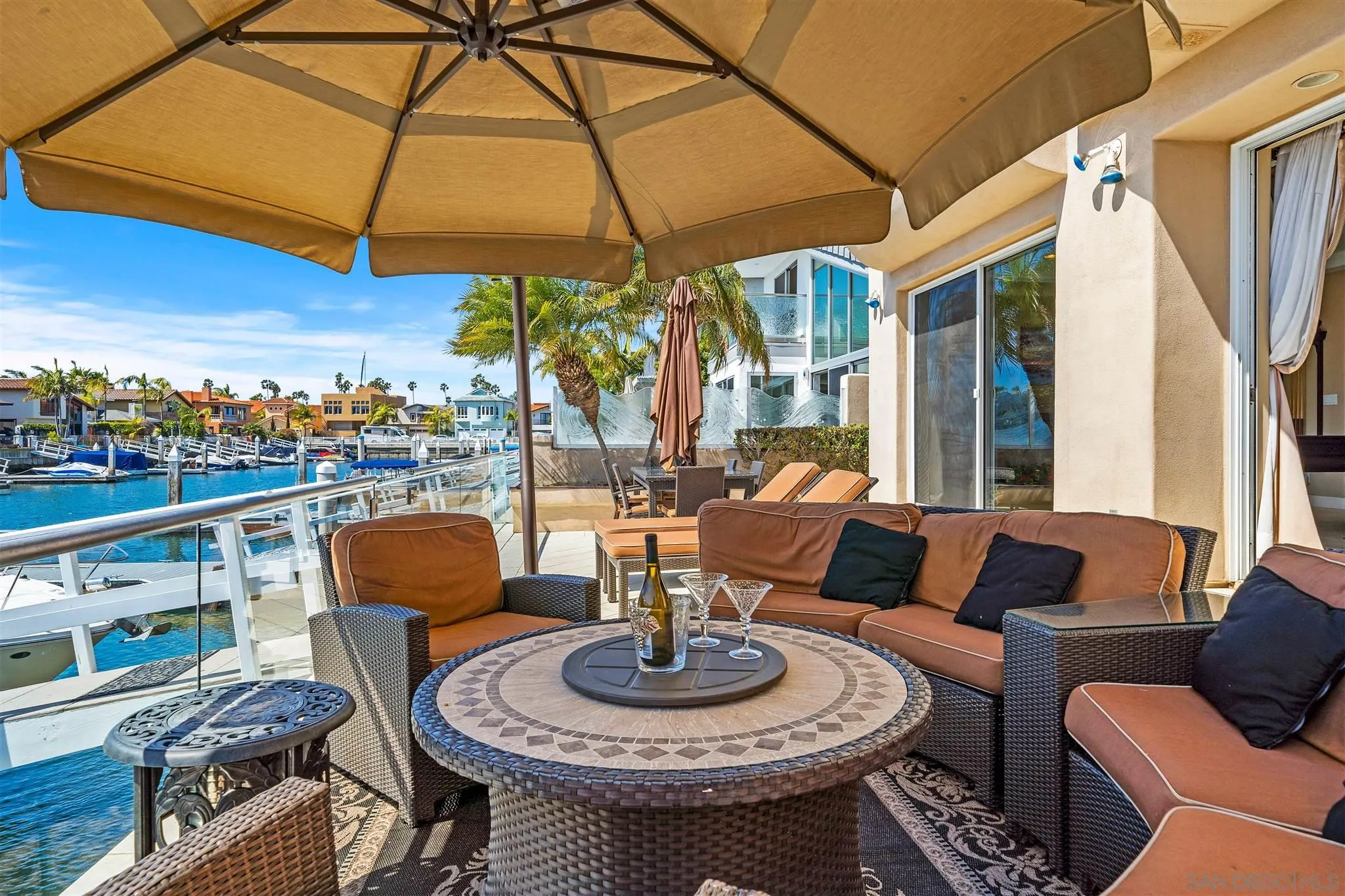 24 Sandpiper Strand Coronado, CA 92118 - Photo 12 of 55 a view of a patio with couches table and chairs under an umbrella
