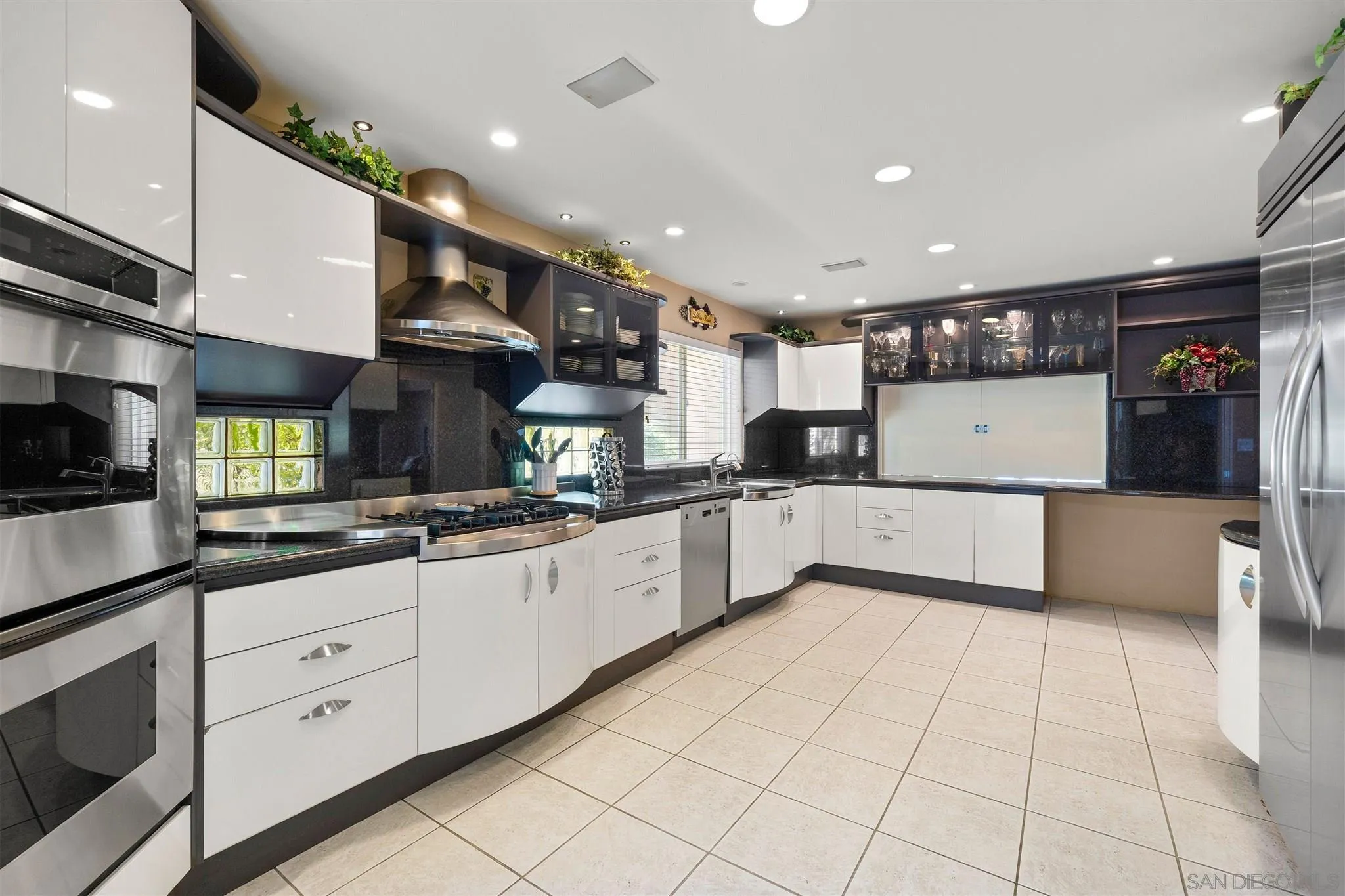 24 Sandpiper Strand Coronado, CA 92118 - Photo 26 of 55 a large kitchen with stainless steel appliances lots of counter space and wooden floor