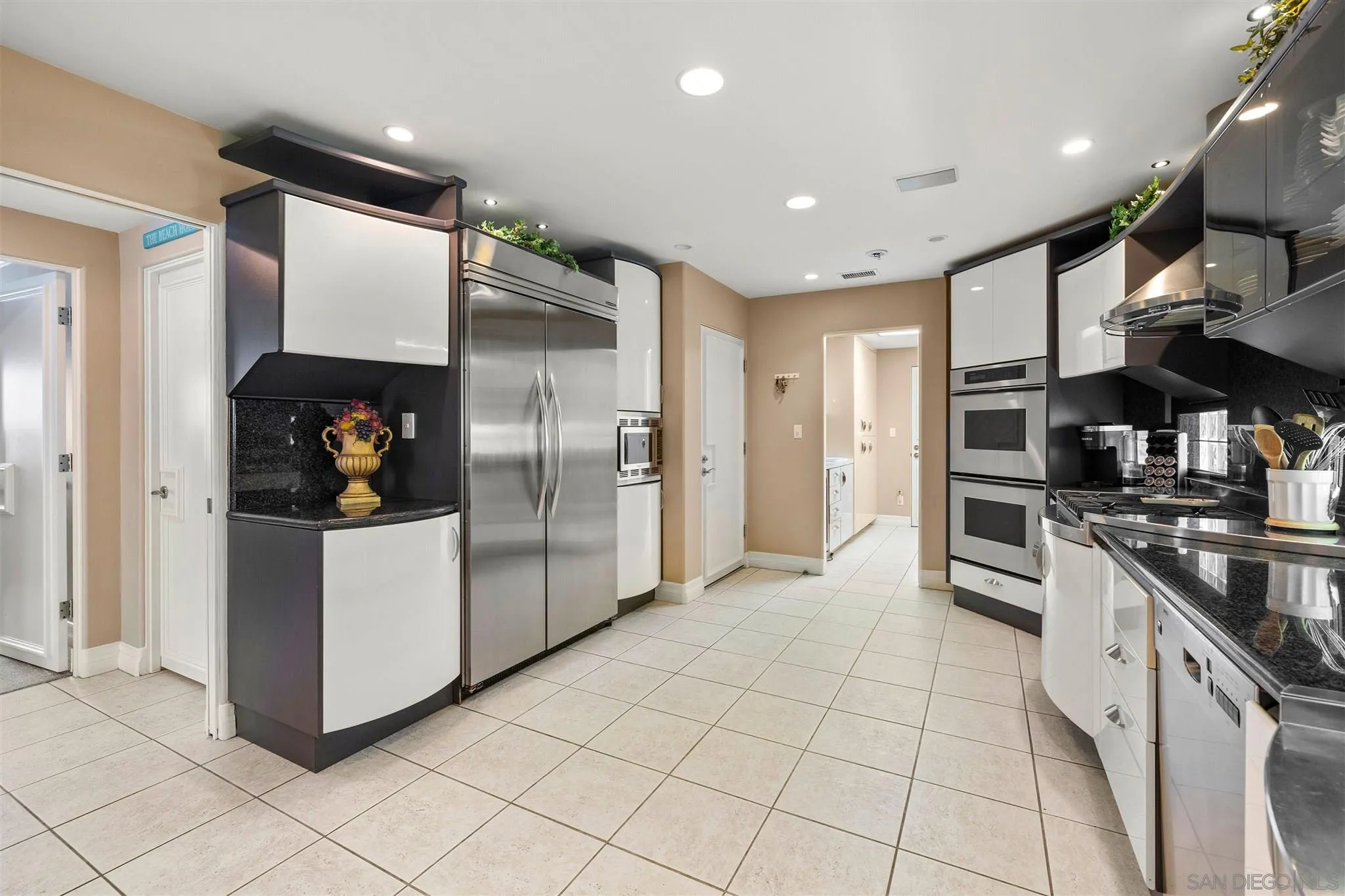 24 Sandpiper Strand Coronado, CA 92118 - Photo 27 of 55 a kitchen with stainless steel appliances granite countertop a refrigerator and a stove