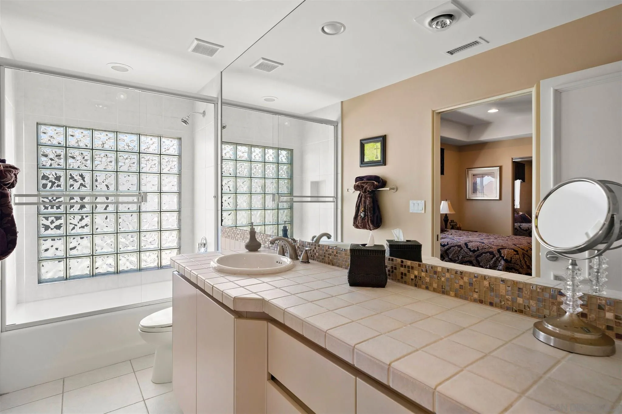24 Sandpiper Strand Coronado, CA 92118 - Photo 44 of 55 a spacious bathroom with a double vanity sink a mirror and a shower