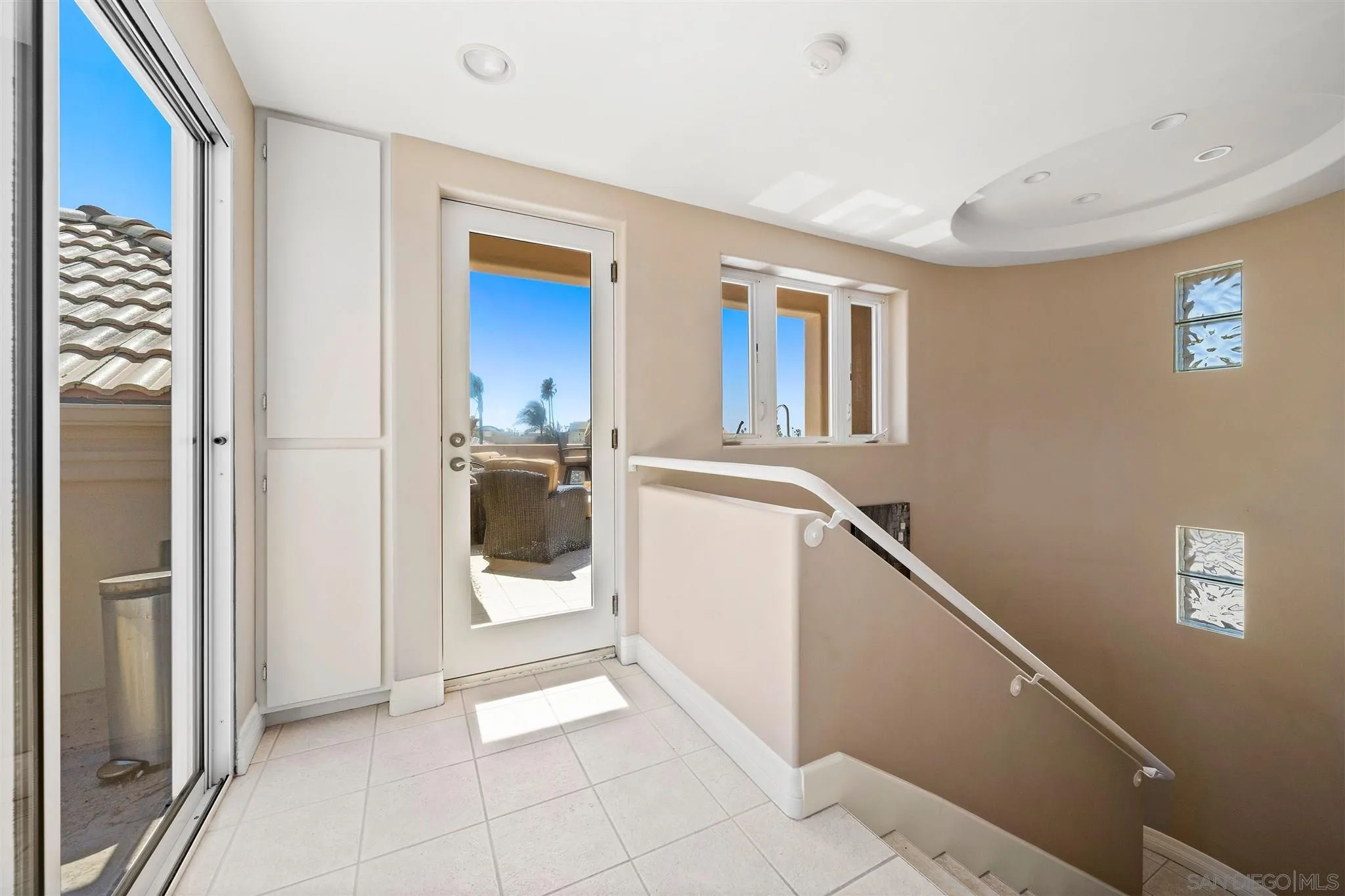 24 Sandpiper Strand Coronado, CA 92118 - Photo 49 of 55 a view of a hallway with an entryway and livingroom with furniture