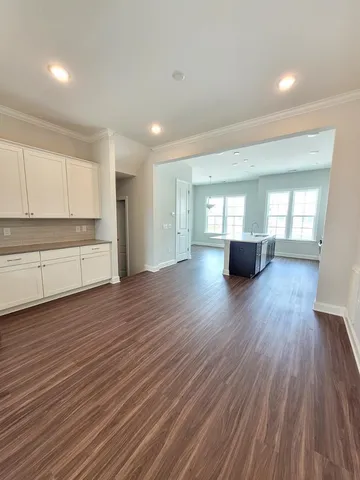 a view of empty room with wooden floor and window