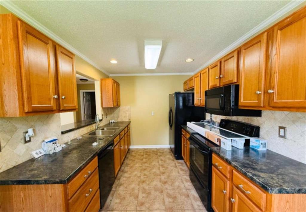 153 Crest Pointe Bremen, GA 30110 - Photo 6 of 24 a kitchen with stainless steel appliances granite countertop a stove a sink and a microwave