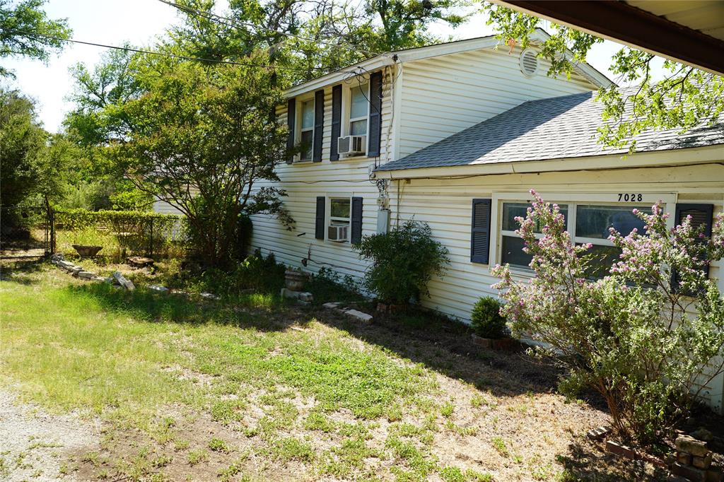 7028 Edgewater Trail Fort Worth, TX 76135 - Photo 7 of 12 a view of house with garden space and swimming pool