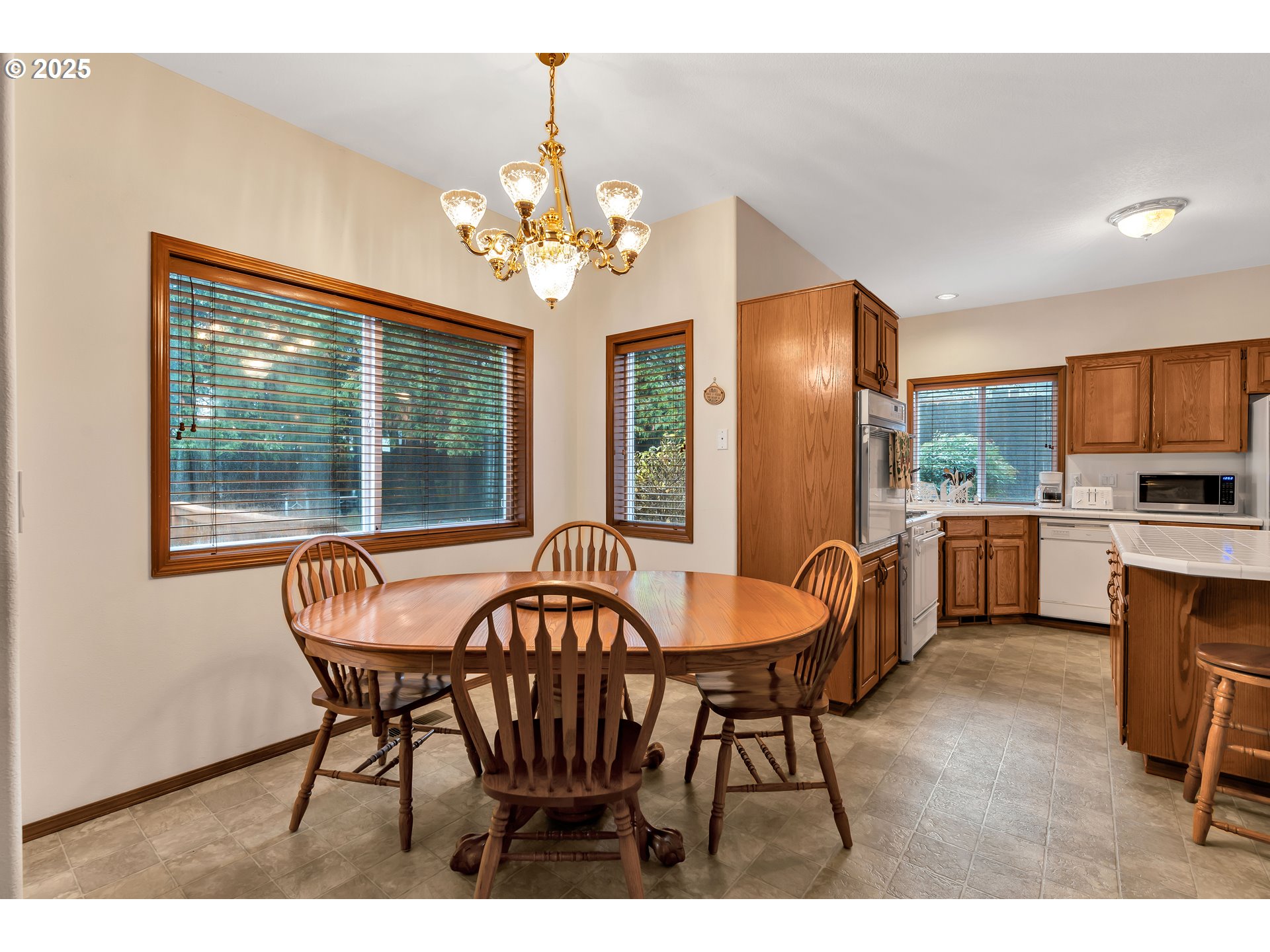 7829 Southwest 174th Place Beaverton, OR 97007 - Photo 15 of 45 a dining room with furniture a chandelier and wooden floor