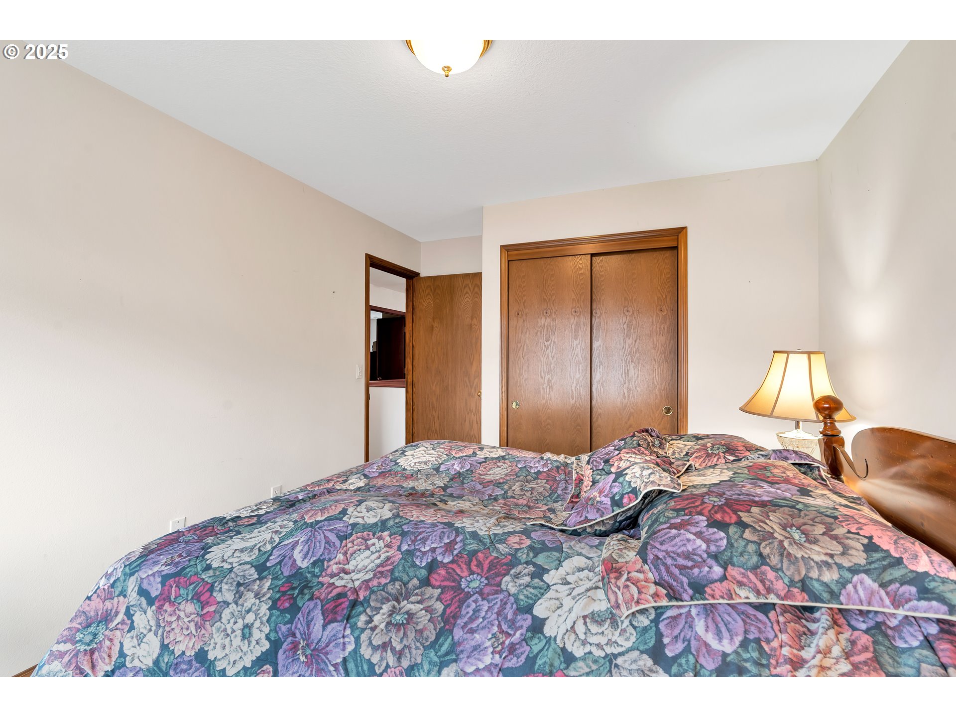 7829 Southwest 174th Place Beaverton, OR 97007 - Photo 22 of 45 a bedroom with a bed and a lamp
