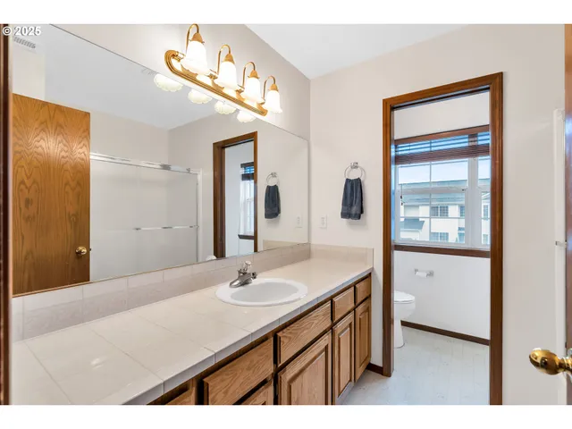 a bathroom with a sink vanity and a mirror