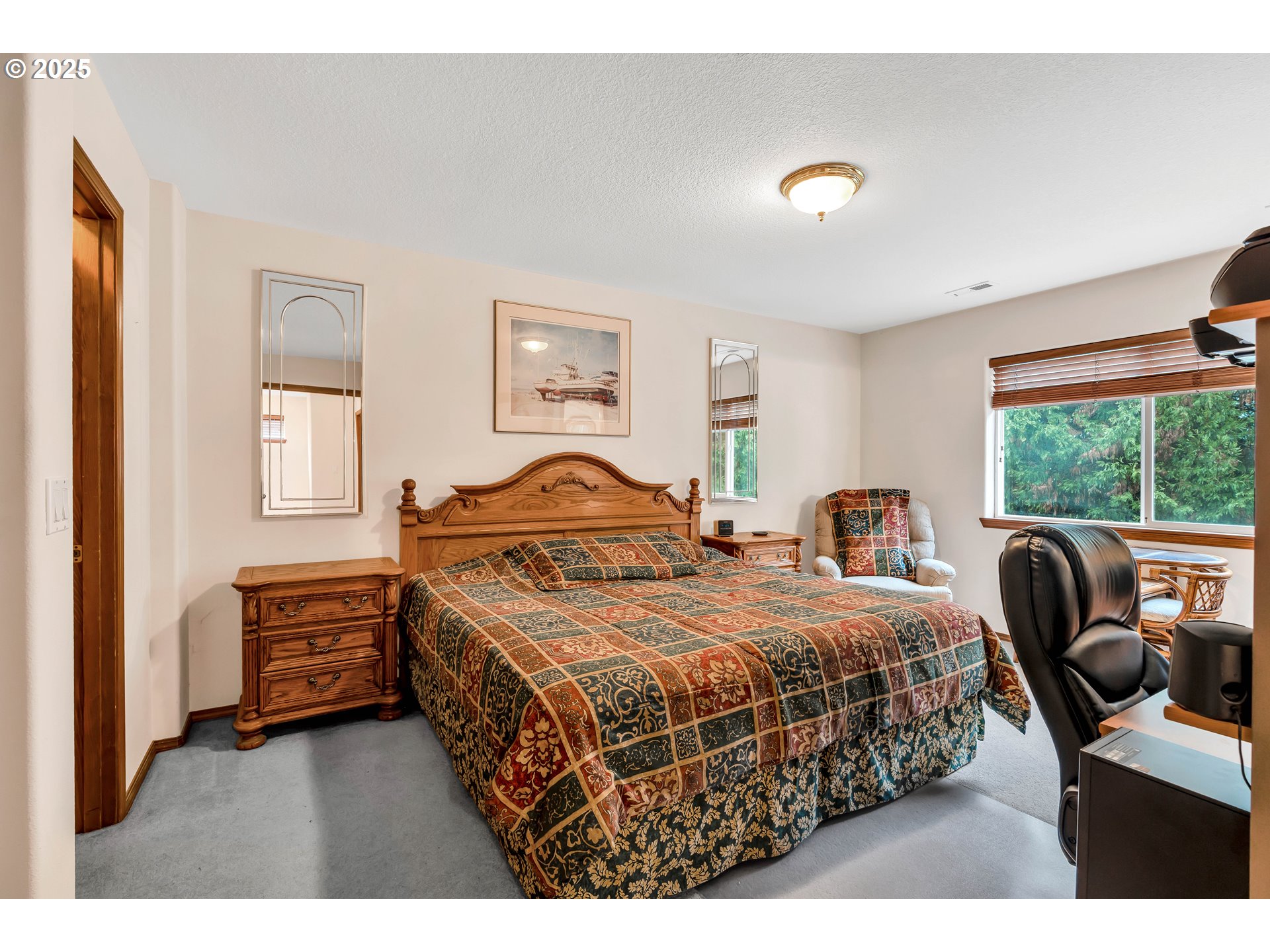7829 Southwest 174th Place Beaverton, OR 97007 - Photo 28 of 45 a bedroom with a bed a couch and a window