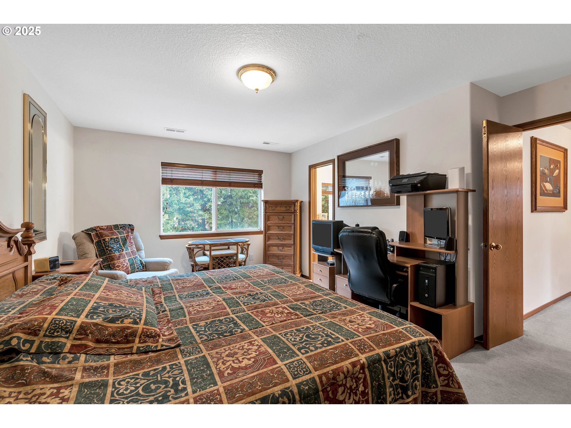 7829 Southwest 174th Place Beaverton, OR 97007 - Photo 29 of 45 a bedroom with a bed and wooden floor