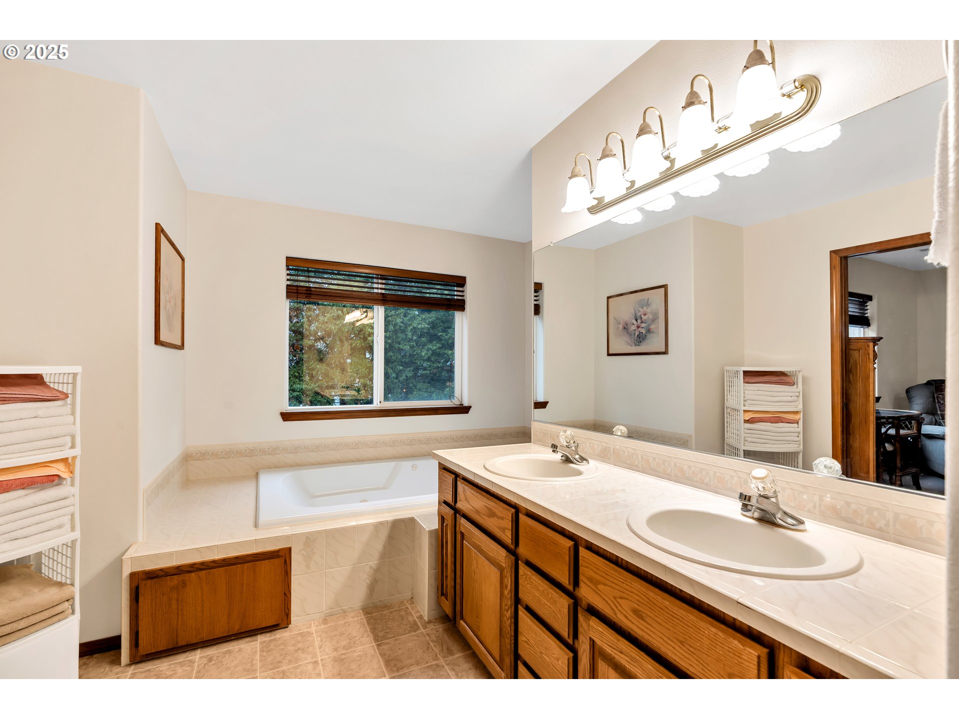 7829 Southwest 174th Place Beaverton, OR 97007 - Photo 32 of 45 a bathroom with a sink a large mirror and a bathtub