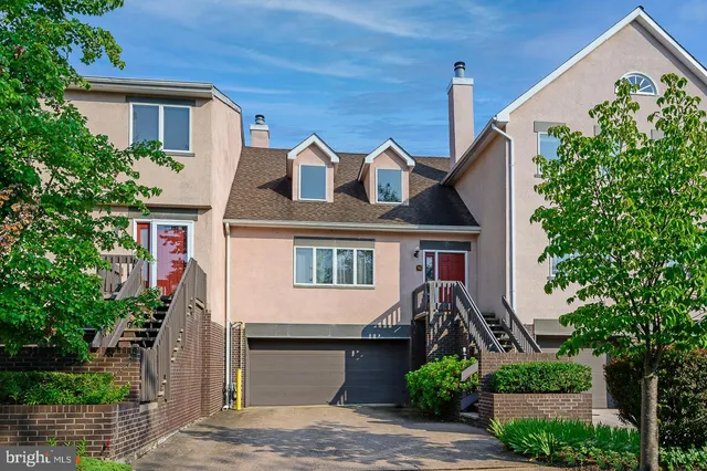 a front view of a house with plants