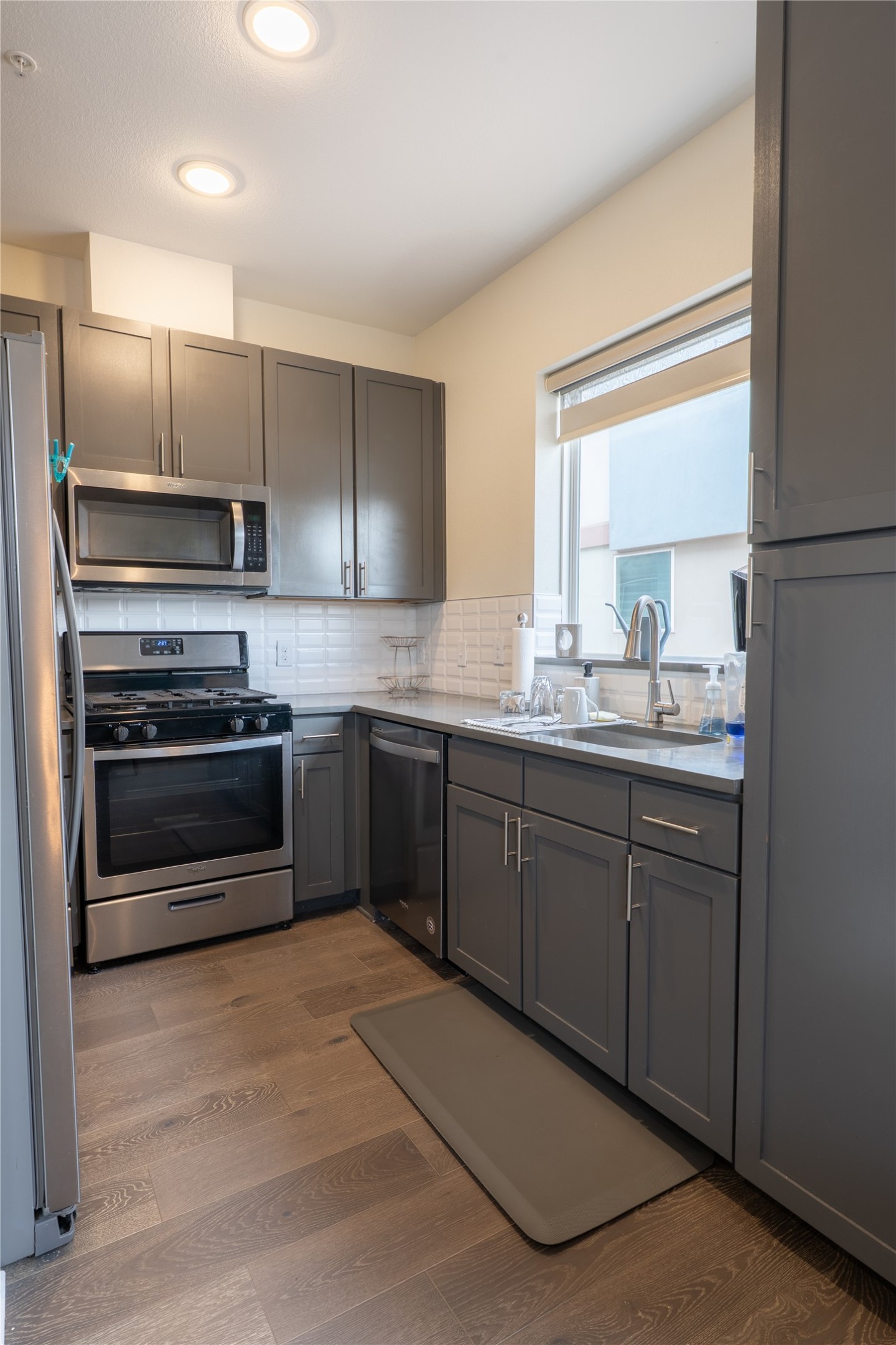2827 Manor Road, Unit 4101 Austin, TX 78722 - Photo 15 of 38 The kitchen features a window, recessed lighting, and stainless steel appliances