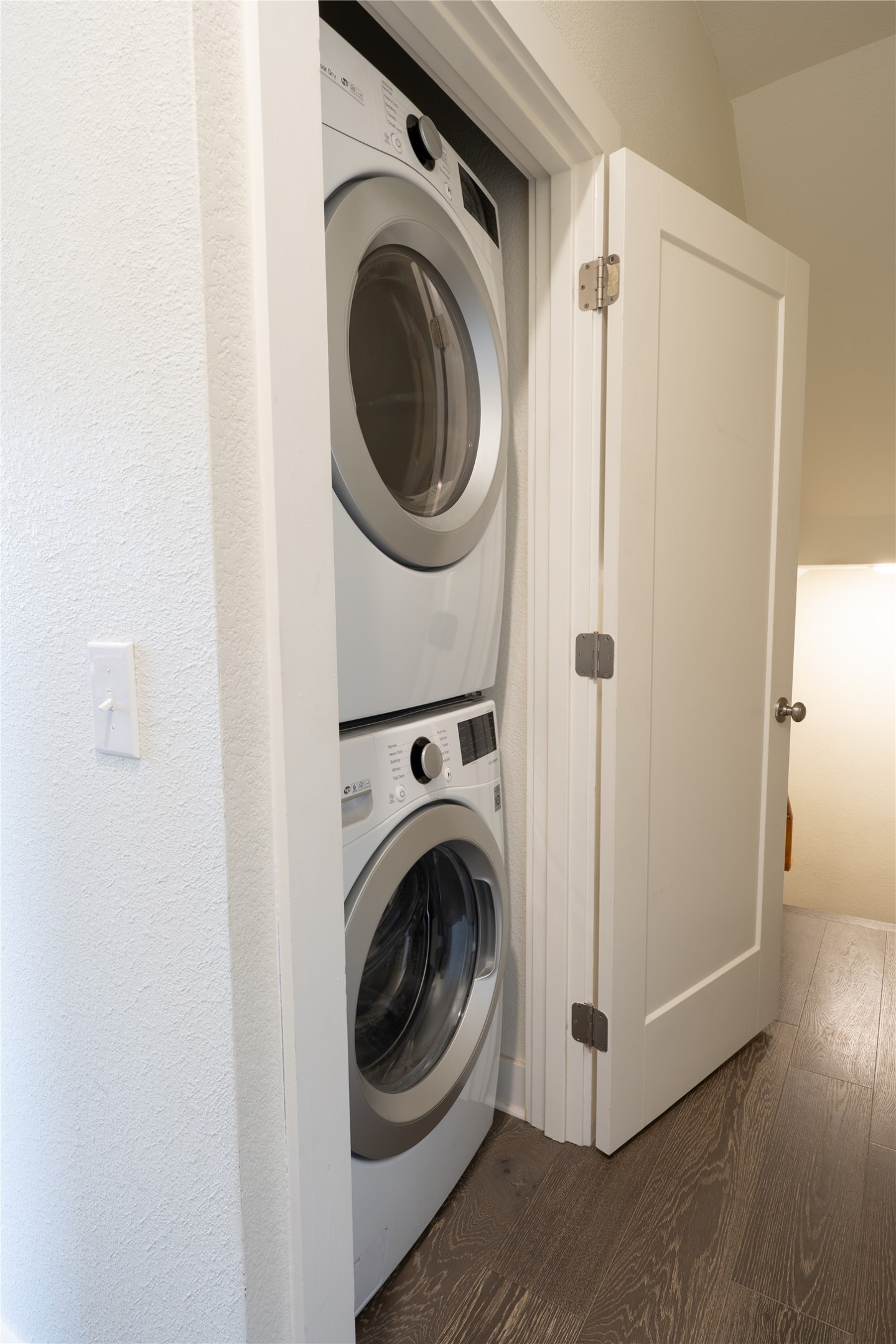 2827 Manor Road, Unit 4101 Austin, TX 78722 - Photo 18 of 38 A convenient laundry area featuring a stacked washer and dryer, situated within a dedicated closet