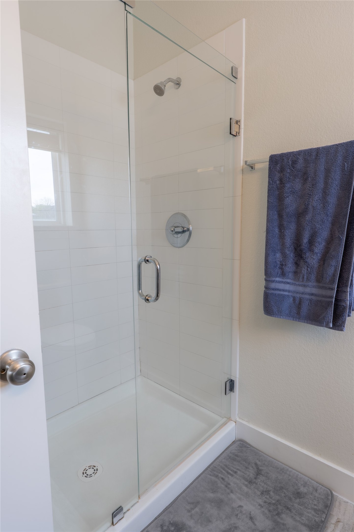 2827 Manor Road, Unit 4101 Austin, TX 78722 - Photo 21 of 38 This bathroom features a contemporary shower with a clear glass enclosure and a chrome shower head and faucet