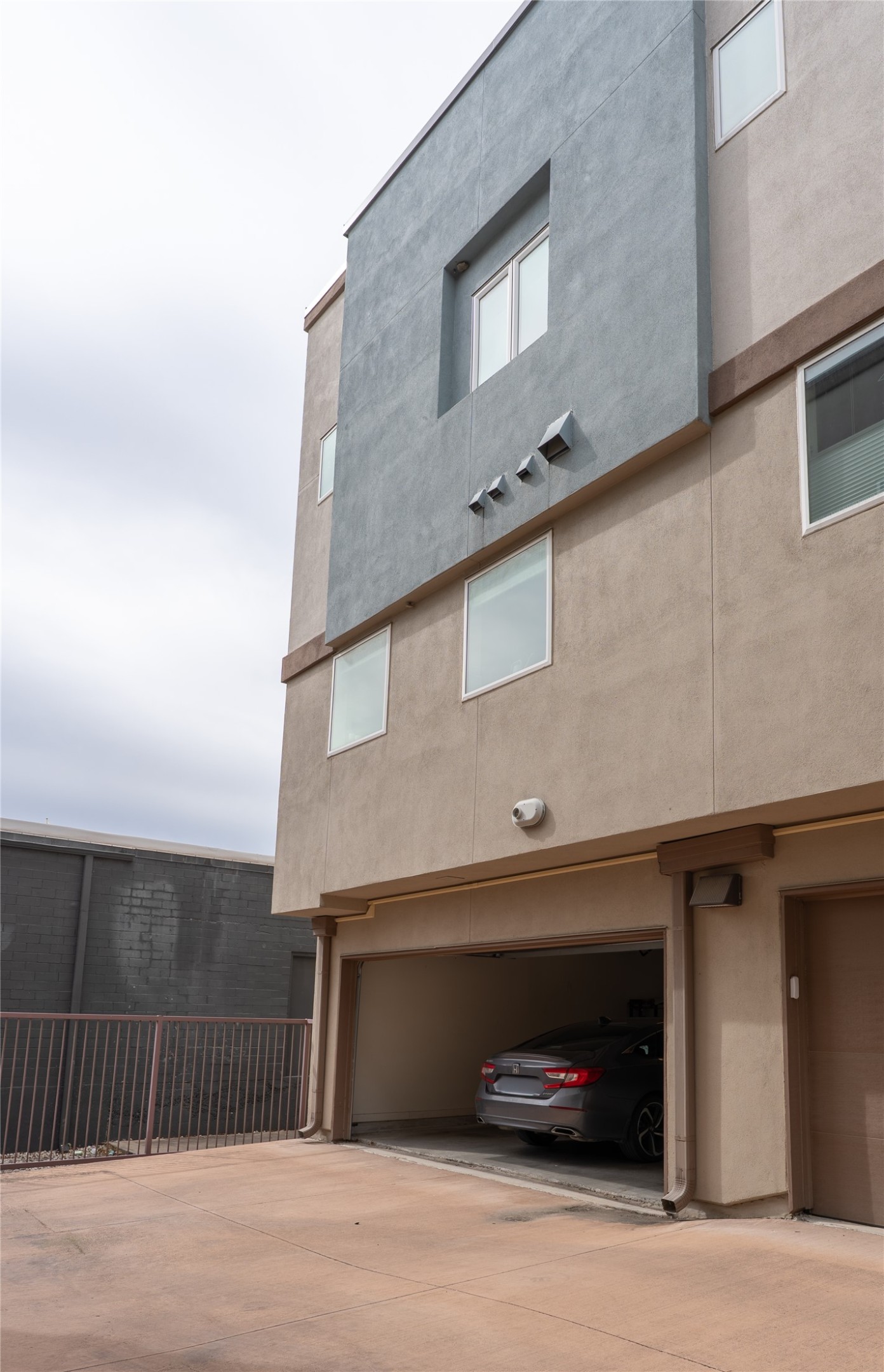 2827 Manor Road, Unit 4101 Austin, TX 78722 - Photo 38 of 38 The property features a multi-story exterior with a blend of light brown and gray finishes, providing a modern aesthetic
