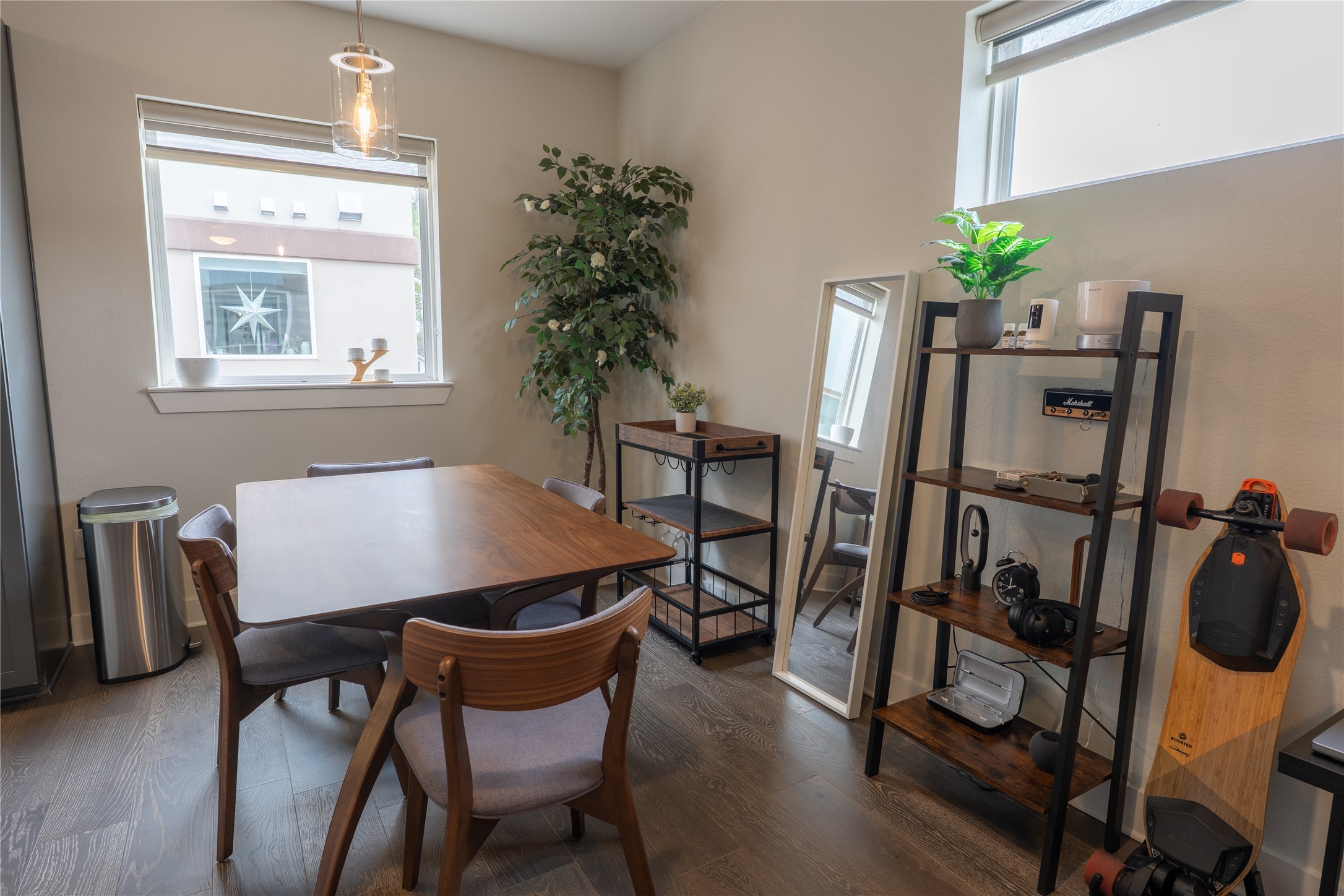 2827 Manor Road, Unit 4101 Austin, TX 78722 - Photo 10 of 38 The property features hardwood floors, a dining area with a rectangular table, and a window with a roller blind