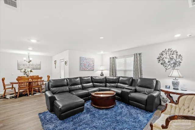 a living room with furniture and a book shelf
