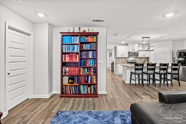 a living room with stainless steel appliances kitchen island granite countertop furniture and a kitchen view