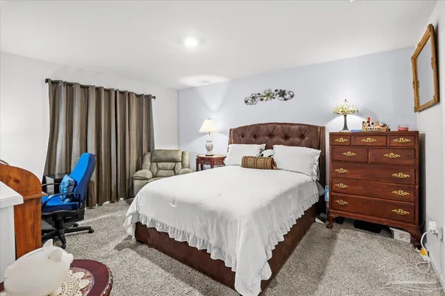 a bedroom with a bed and a lamp