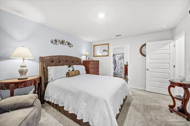 a bedroom with a bed and a television