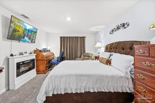 a bathroom with a granite countertop sink a mirror a vanity and a shower