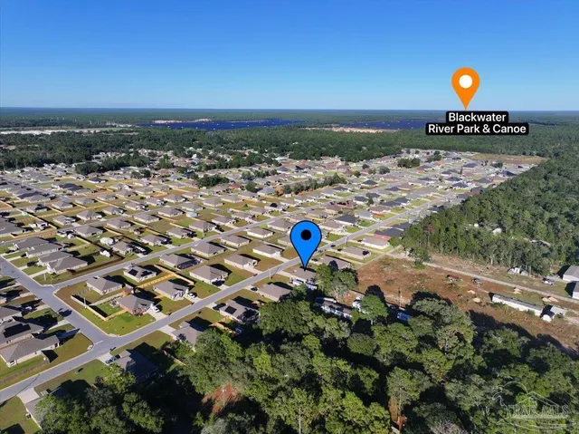an aerial view of a house with a swimming pool